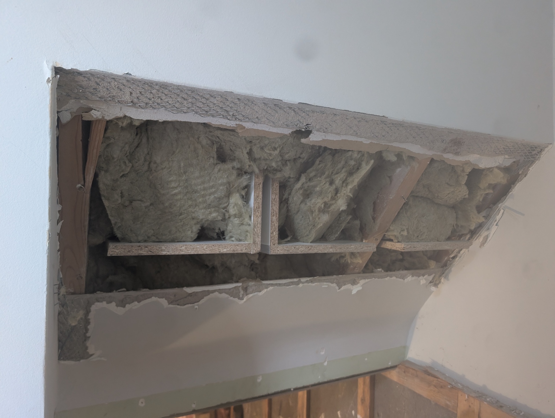 Before — ceiling opened, insulation exposed