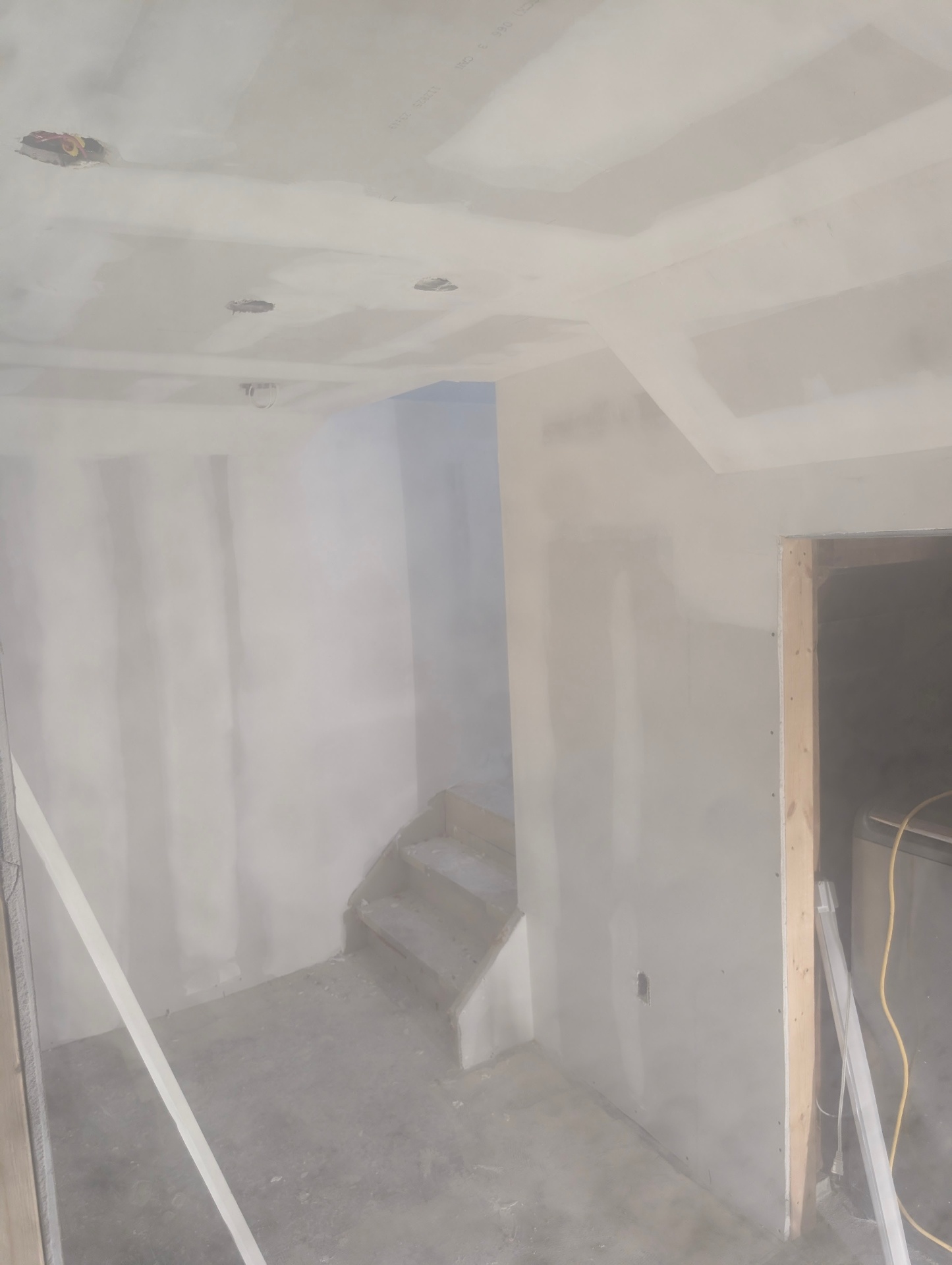 Freshly hung drywall on a basement stairwell in St. Catharines