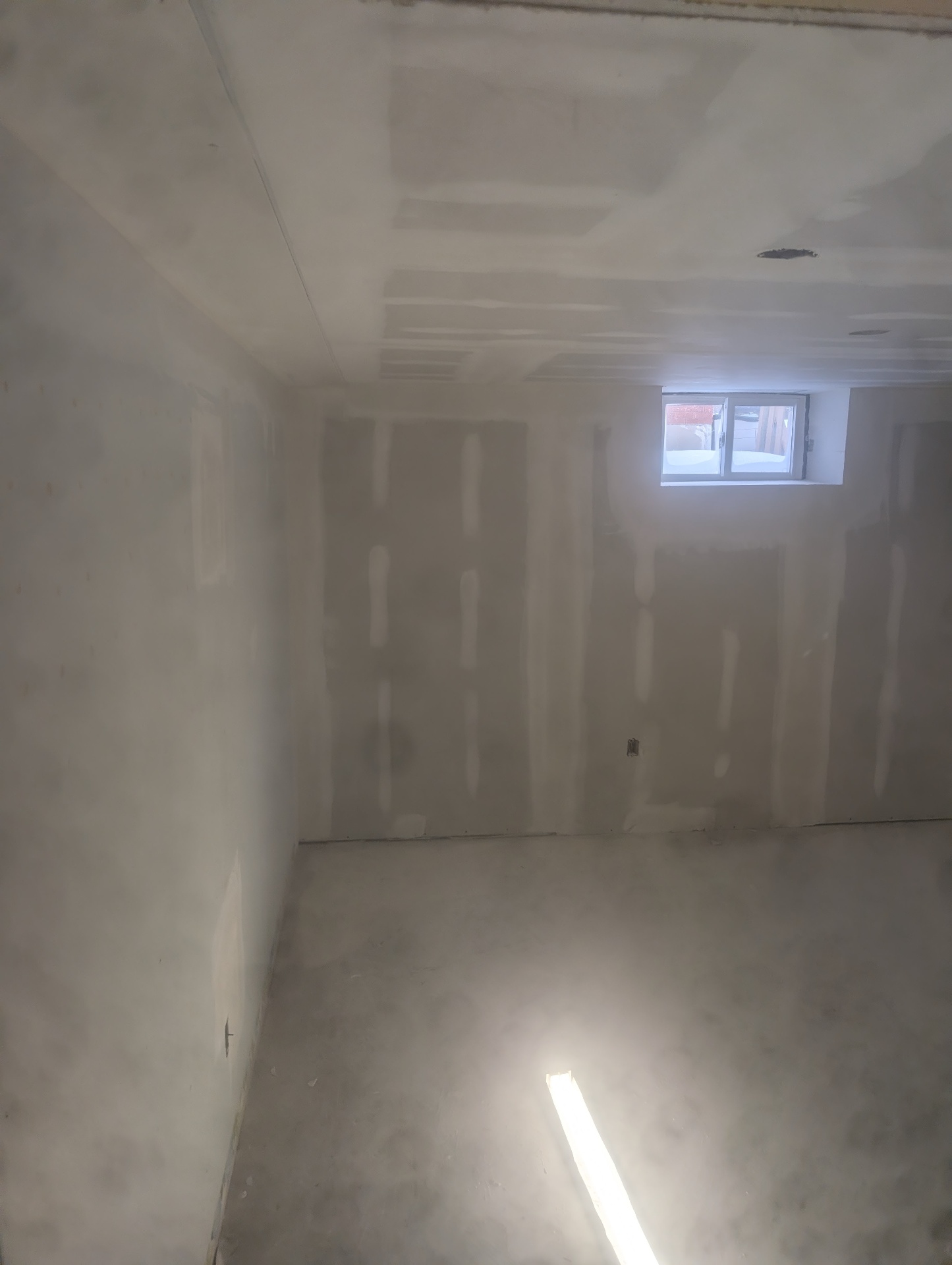 Basement bedroom — clean drywall finish