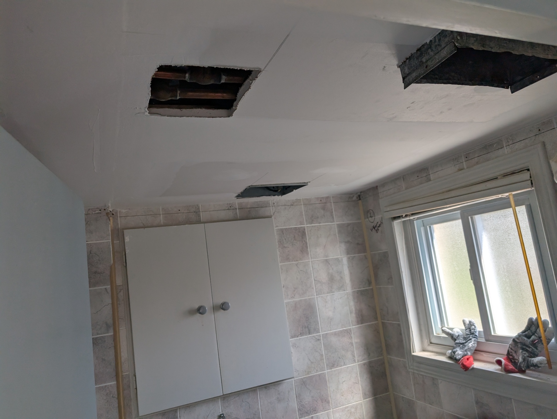 Bathroom ceiling opened to access joists