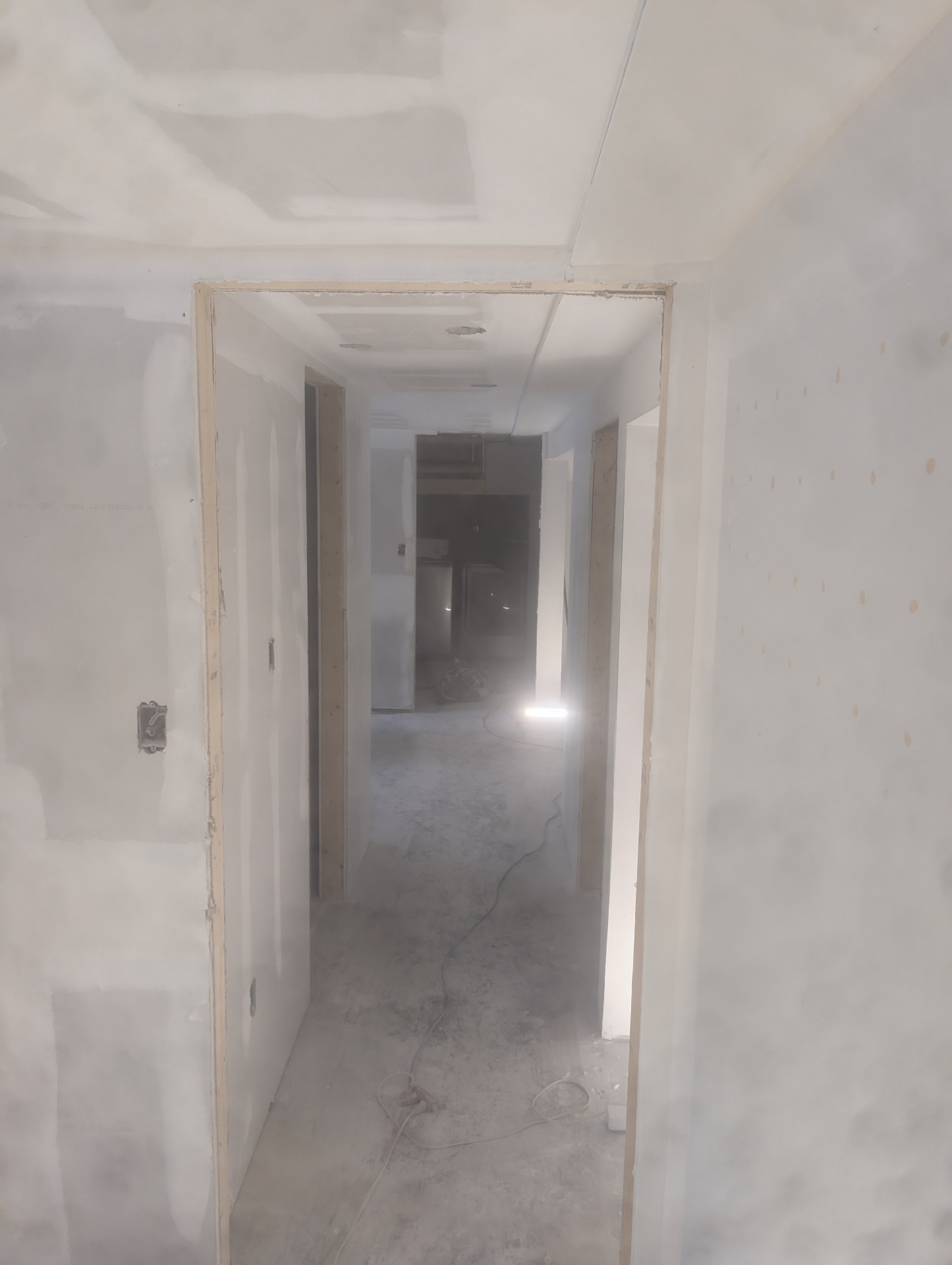 Basement hallway with doorways framed & finished
