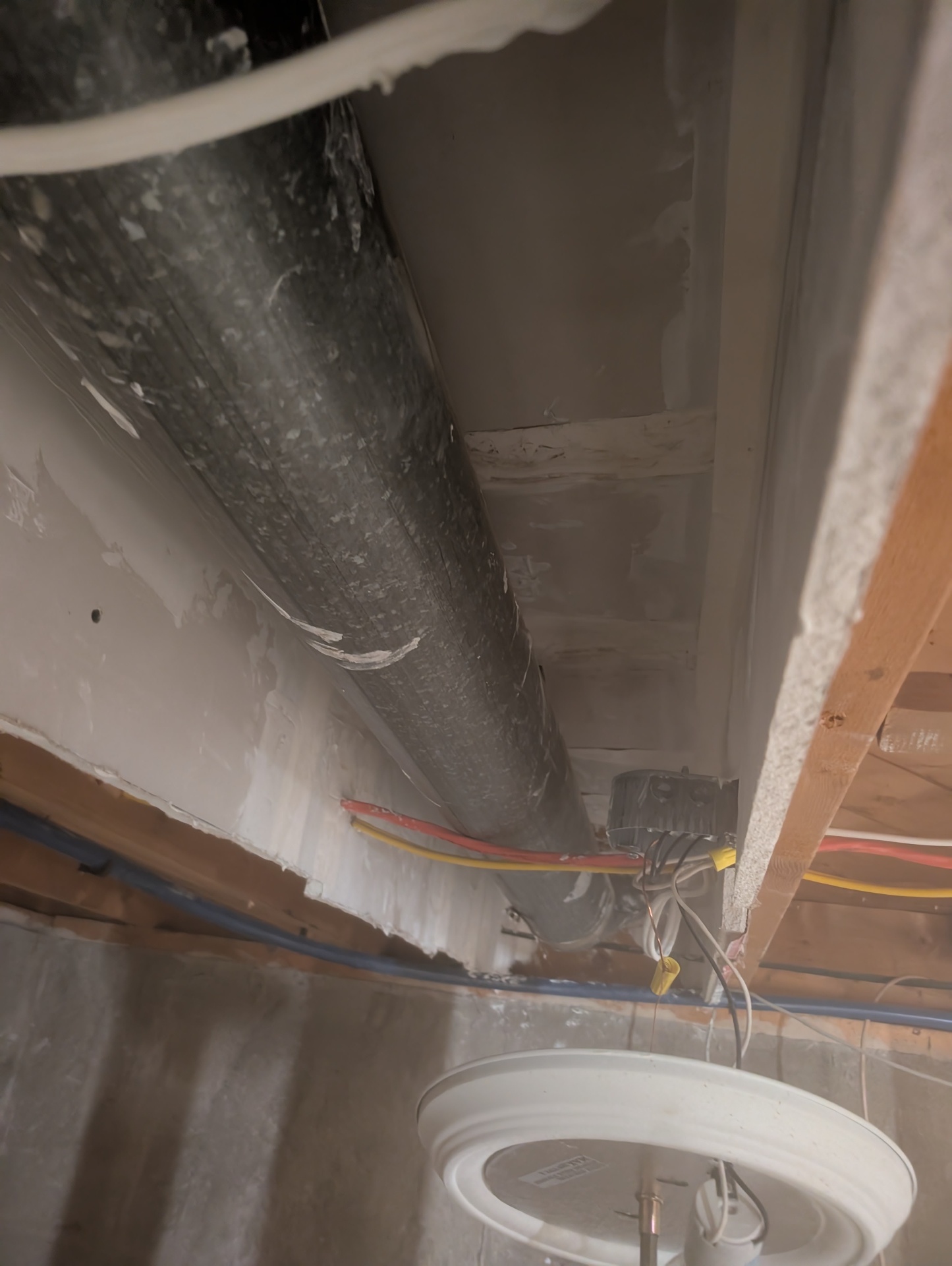 Before — exposed ceiling with pipes & wiring