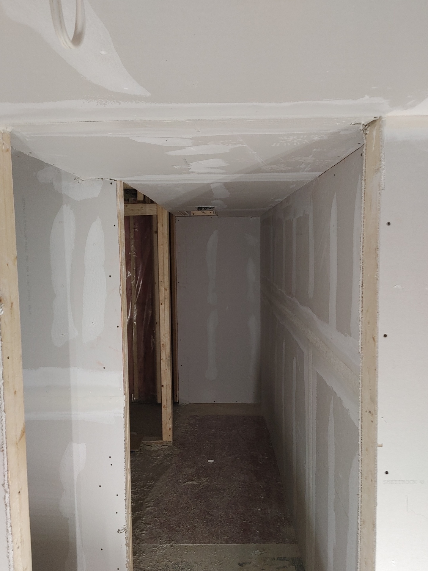 Basement hallway — drywall hung & taped