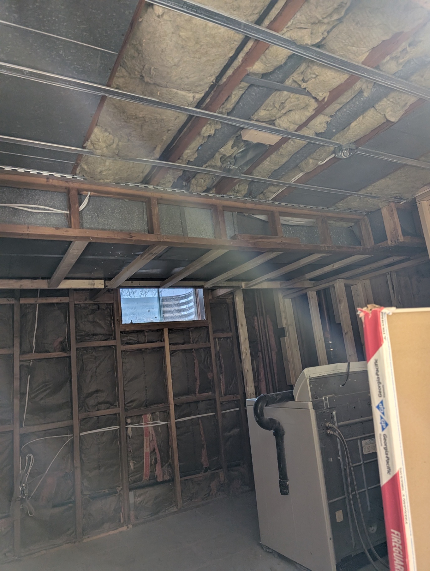 Before — laundry area stripped to studs