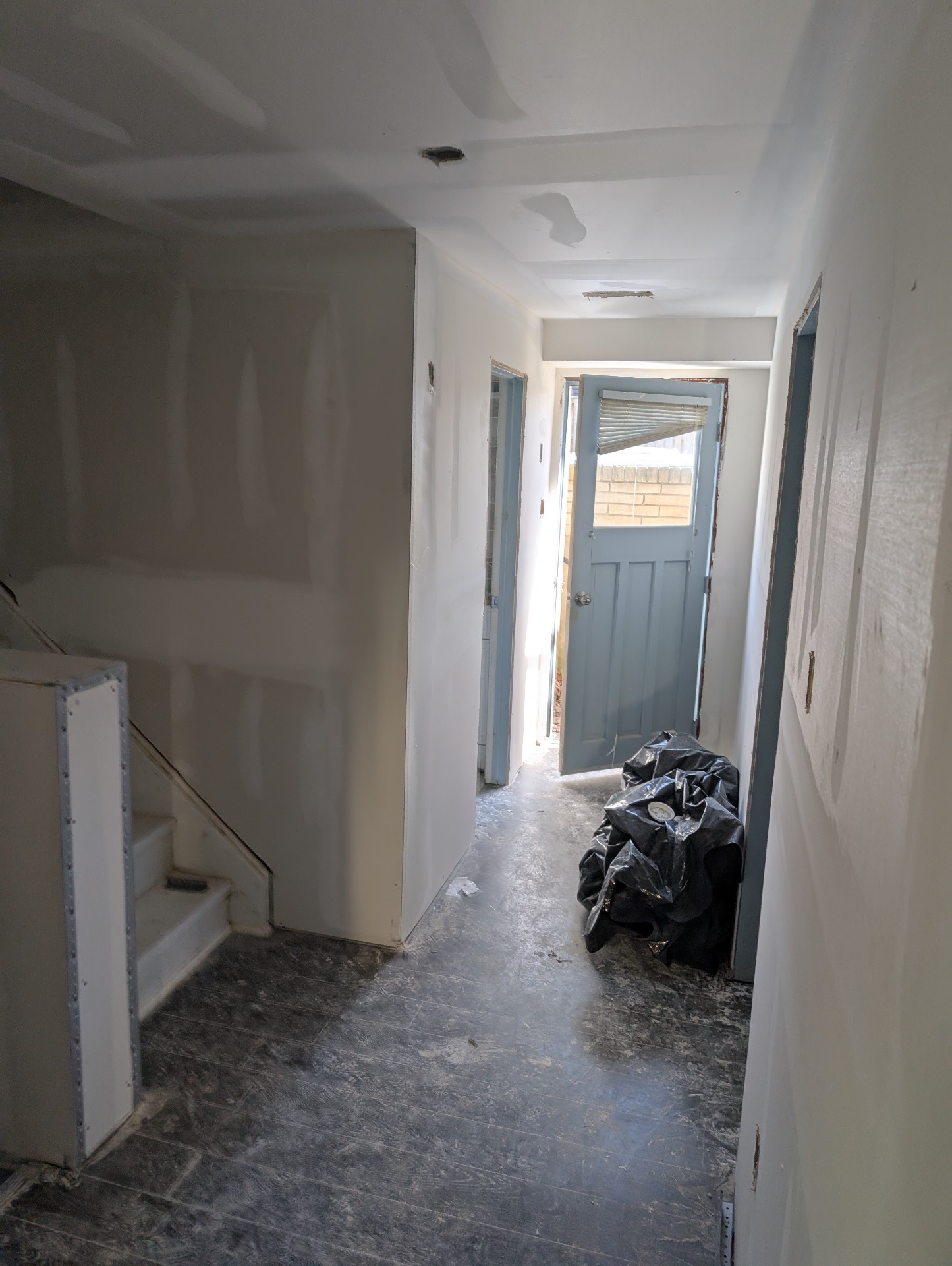 Basement hallway gutted to the studs