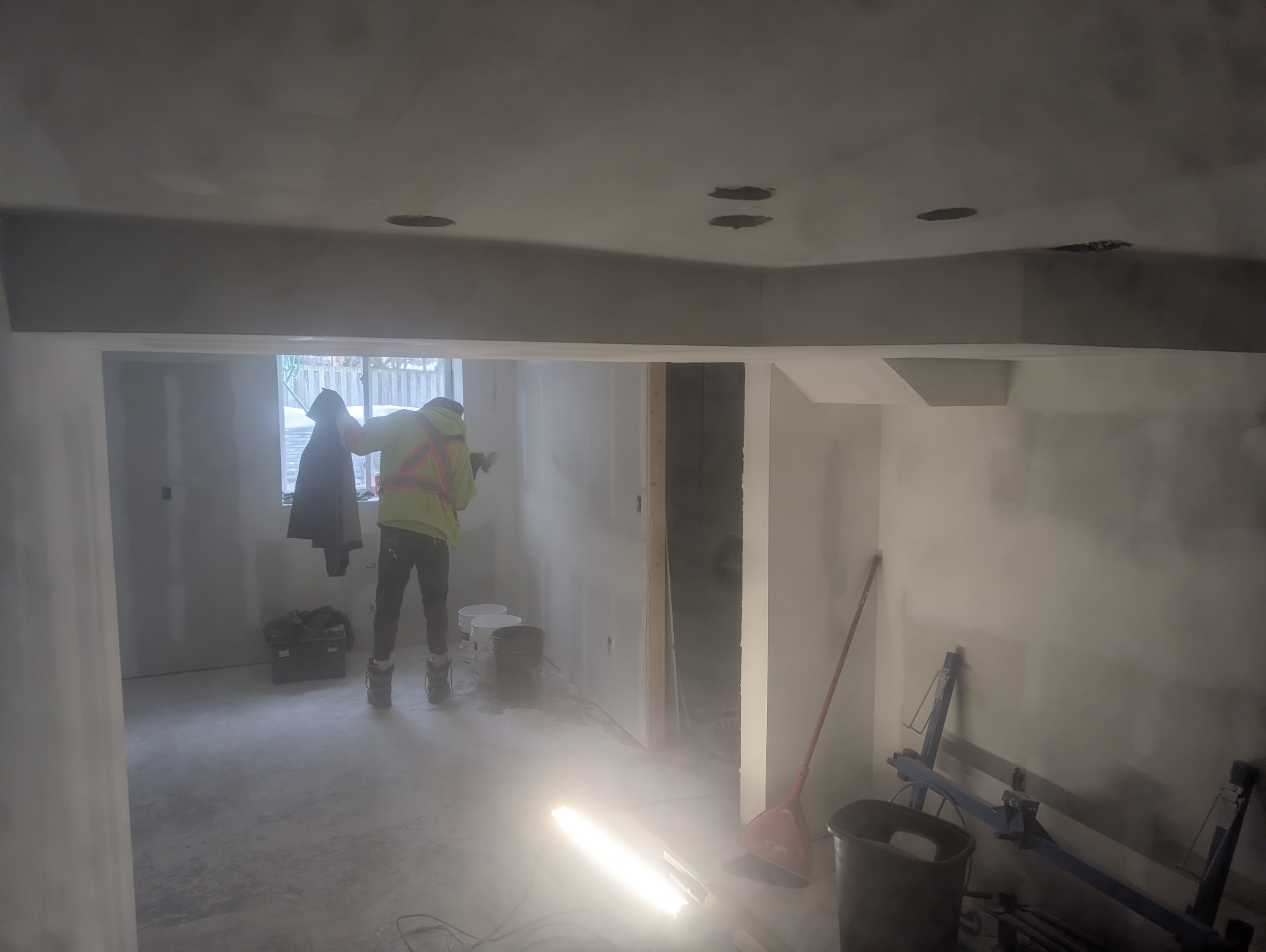 JCA crew installing drywall on a winter basement build