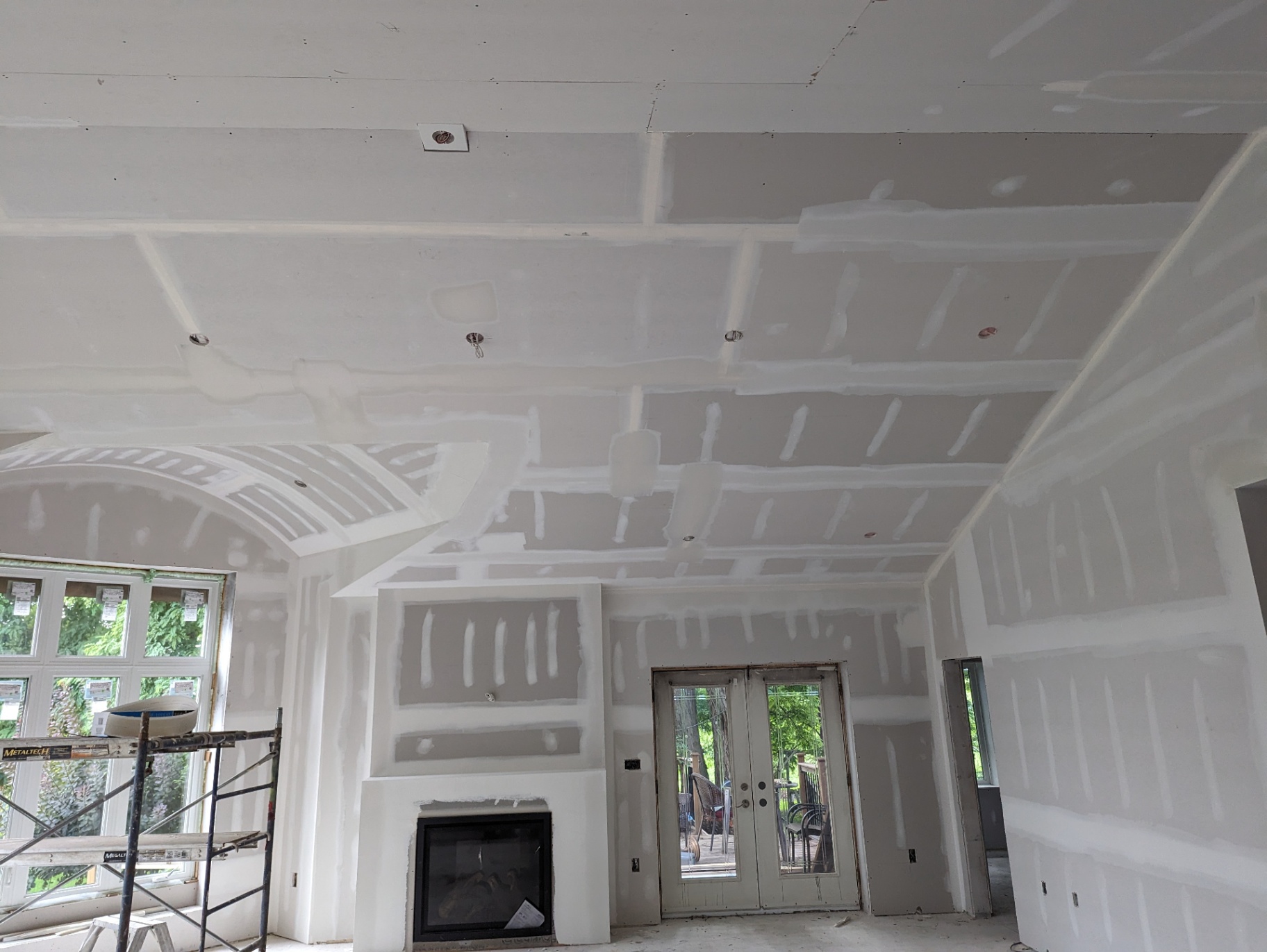 Living room with fireplace bulkhead — finished drywall