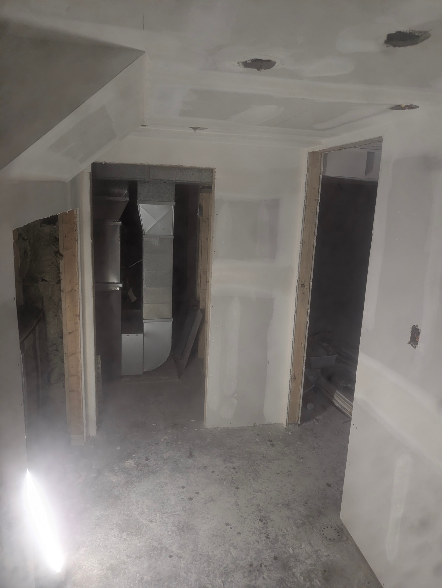 Drywall boxed around mechanical ductwork during a basement renovation